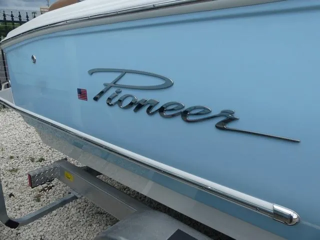 Slide: The Image of 2025 Pioneer Islander 222 boat with outboard motor in a marina. - 7