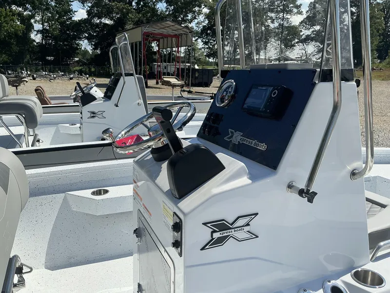 Slide: The Image of 2025 Xpress H20B NEW CONSOLE boat with modern steering and control panel. - 4