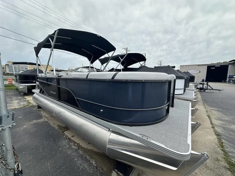 Slide: The Image of 2024 Crest Classic LX 220 SLC pontoon boat with canopy, docked at a marina. - 1