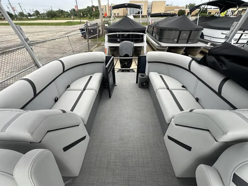 Slide: The Image of 2024 Crest Classic LX 220 SLC pontoon boat interior with gray seating and flooring. - 11