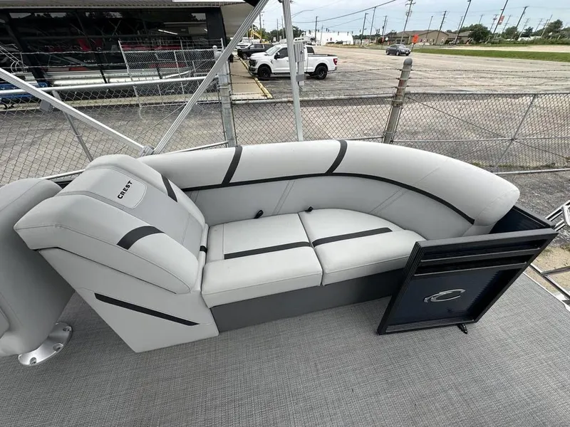 Slide: The Image of 2024 Crest Classic LX 220 SLC pontoon boat with gray seating and black accents. - 12
