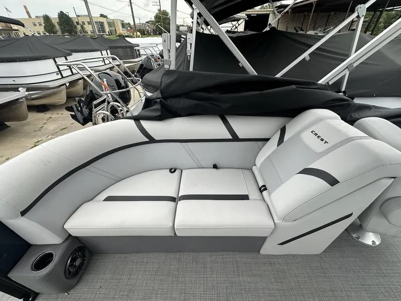 Slide: The Image of 2024 Crest Classic LX 220 SLC pontoon boat interior with gray seating and cup holder. - 13