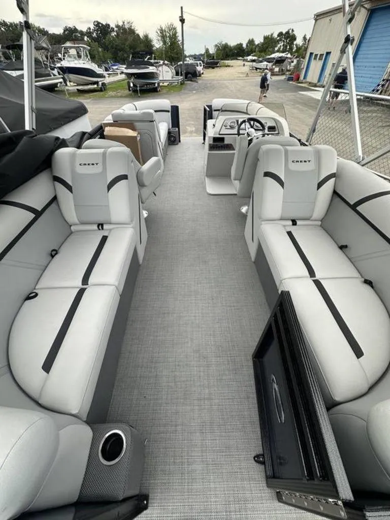 Slide: The Image of Interior of 2024 Crest Classic LX 220 SLC pontoon boat with spacious seating. - 2