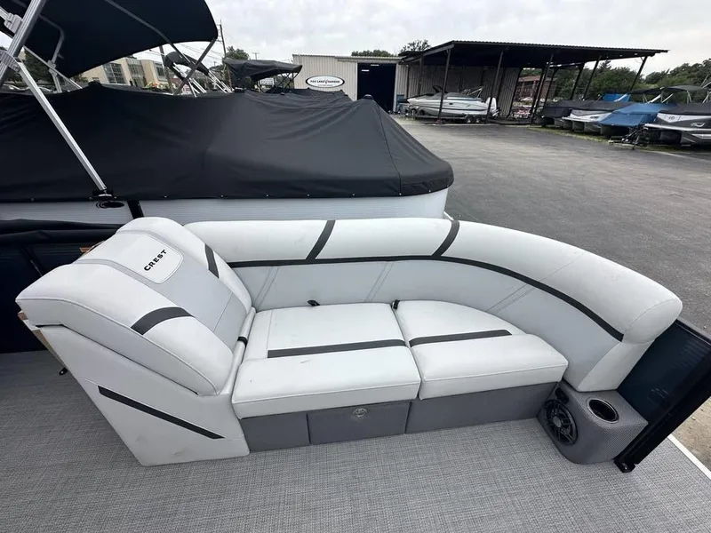 Slide: The Image of 2024 Crest Classic LX 220 SLC boat with white and gray cushioned seating. - 4
