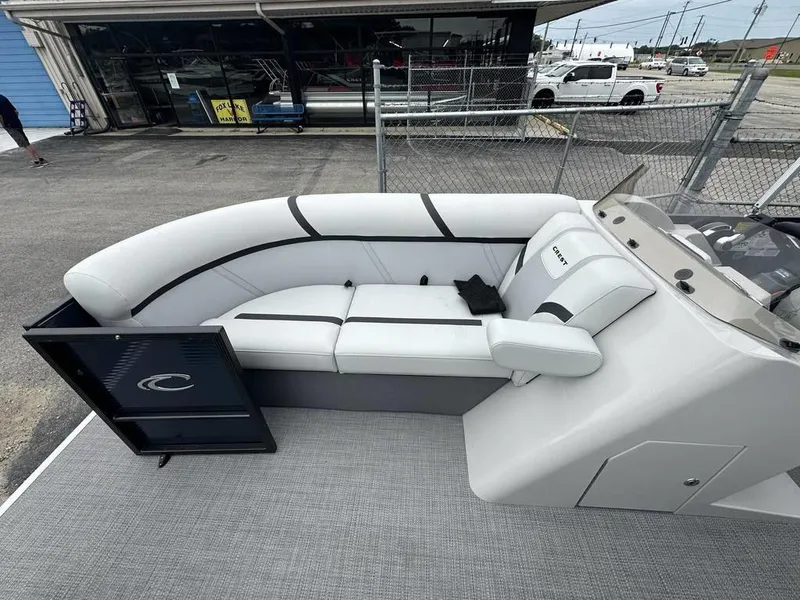 Slide: The Image of 2024 Crest Classic LX 220 SLC boat interior with white seating and open gate. - 5
