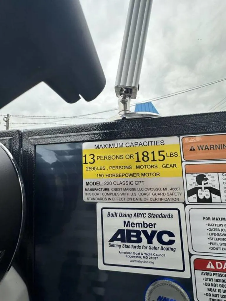 Slide: The Image of 2024 Crest Classic LX 220 SLC boat capacity label, 13 persons or 1815 lbs, 150 HP motor. - 9