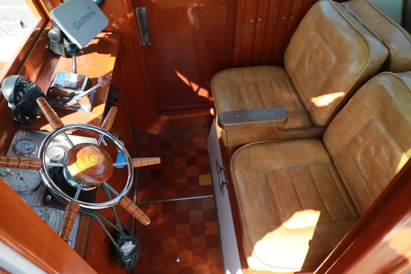 Slide: The Image of 1982 Shamrock Pilothouse interior with wooden steering wheel and leather seats. - 10