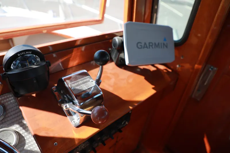 Slide: The Image of 1982 Shamrock Pilothouse helm with Garmin GPS, Morse engine control, and Ritchie compass. - 12