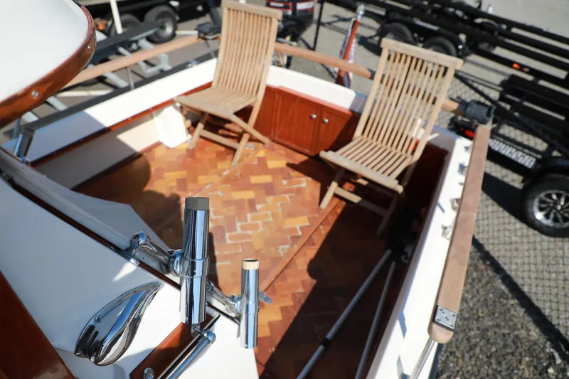 Slide: The Image of 1982 Shamrock Pilothouse boat deck with wooden chairs and parquet flooring. - 14