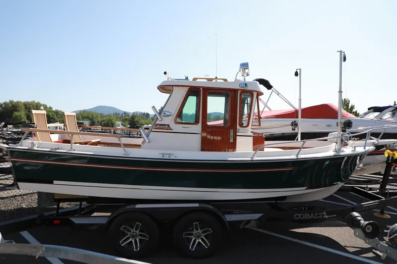 Slide: The Image of 1982 Shamrock Pilothouse boat on a trailer in a marina parking lot. - 3