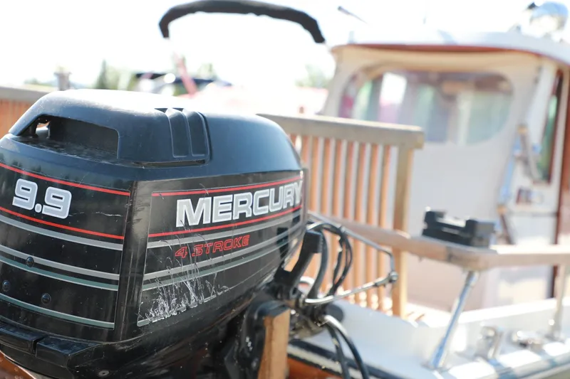 Slide: The Image of Close-up of a Mercury 9.9 HP 4-stroke outboard motor on a 1982 Shamrock Pilothouse boat. - 5