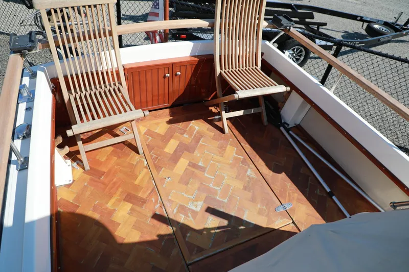 Slide: The Image of 1982 Shamrock Pilothouse boat interior with wooden chairs and parquet flooring. - 6