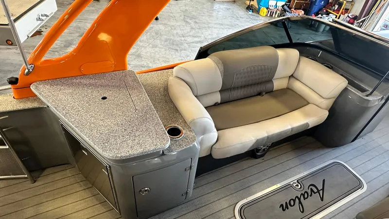 Slide: The Image of 2023 Avalon Excalibur Elite Windshield boat interior with seating and countertop. - 10