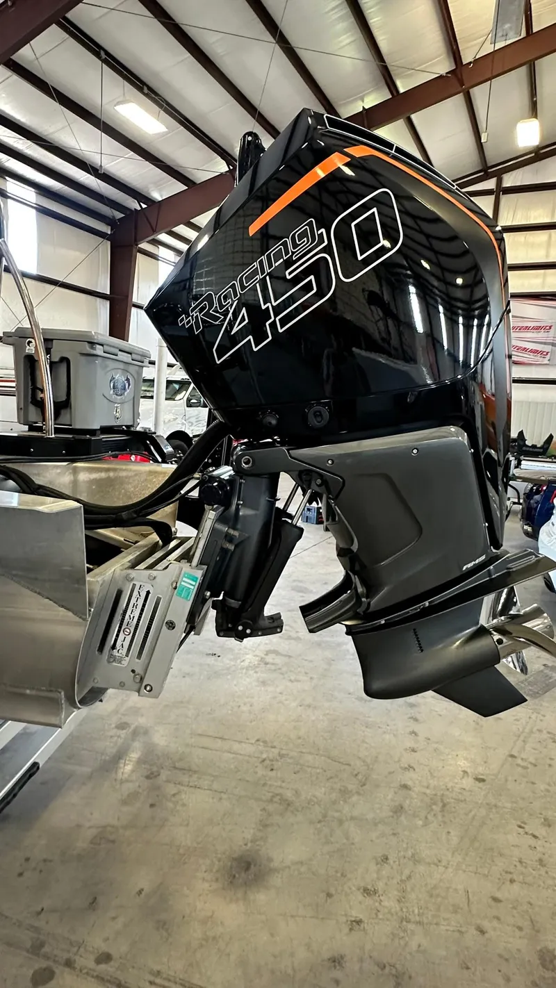 Slide: The Image of 2023 Avalon Excalibur Elite Windshield with powerful Racing 450 outboard motor. - 6