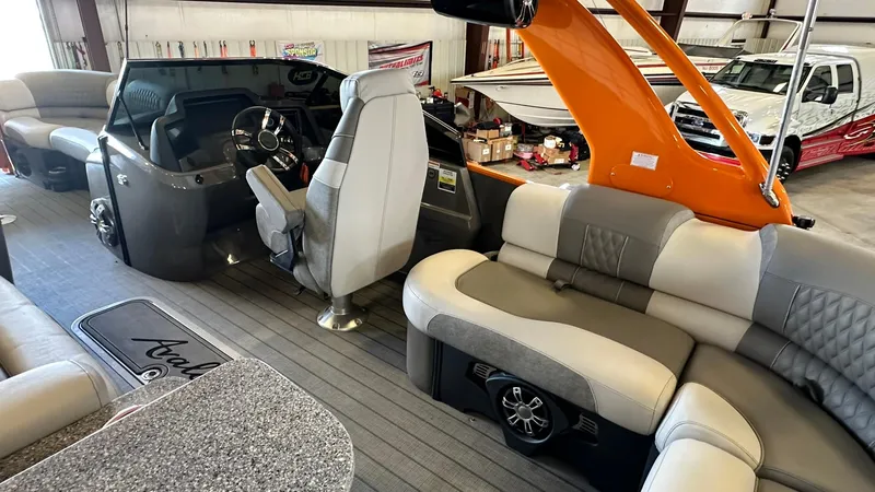 Slide: The Image of 2023 Avalon Excalibur Elite Windshield boat interior with luxury seating and modern dashboard. - 9