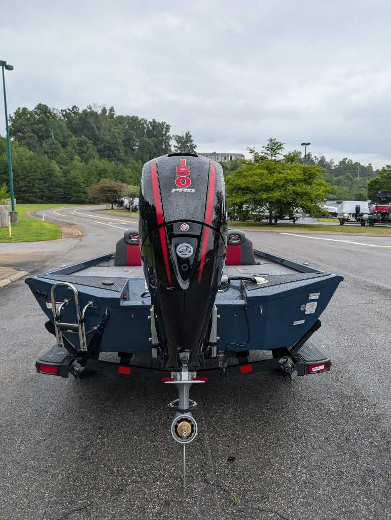 Slide: The Image of 2024 Ranger RT198P boat with powerful outboard motor, parked on a road. - 3