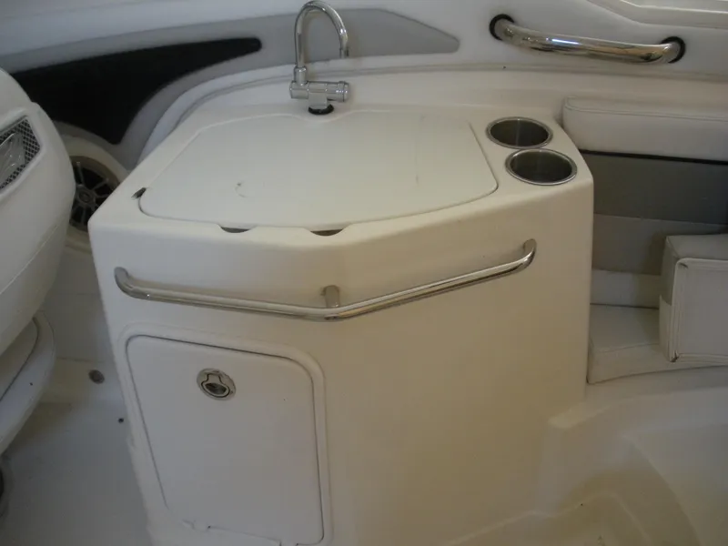 Slide: The Image of 2009 Larson LXi 258 boat interior sink and storage compartment. - 12