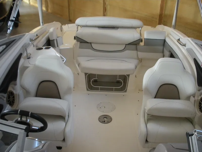 Slide: The Image of 2009 Larson LXi 258 boat interior with white leather seats and steering wheel. - 7