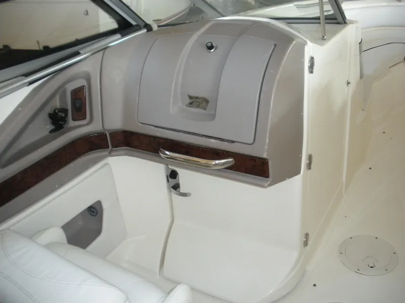 Slide: The Image of 2009 Larson LXi 258 boat interior dashboard and seating area. - 9