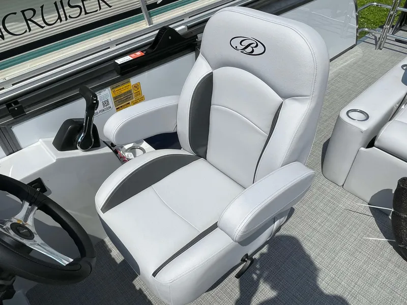 Slide: The Image of 2025 Bentley Pontoons Legacy 220 Swingback captain's chair, luxurious white and gray upholstery. - 13