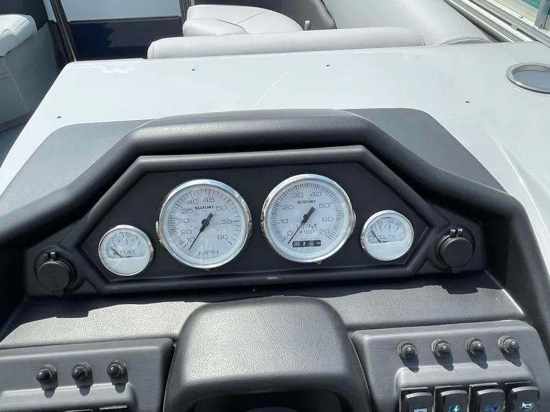 Slide: The Image of 2025 Bentley Pontoons Legacy 220 Swingback dashboard with gauges and controls. - 15