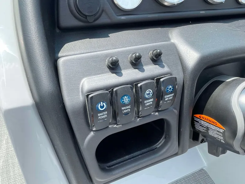 Slide: The Image of Control panel of 2025 Bentley Pontoons Legacy 220 Swingback with switches for power and lights. - 16