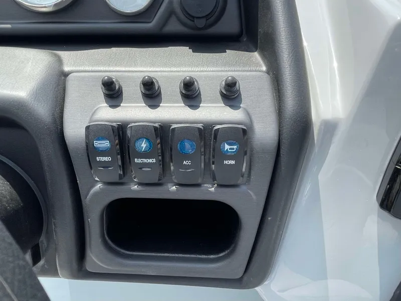 Slide: The Image of Control panel of 2025 Bentley Pontoons Legacy 220 Swingback with labeled switches. - 17