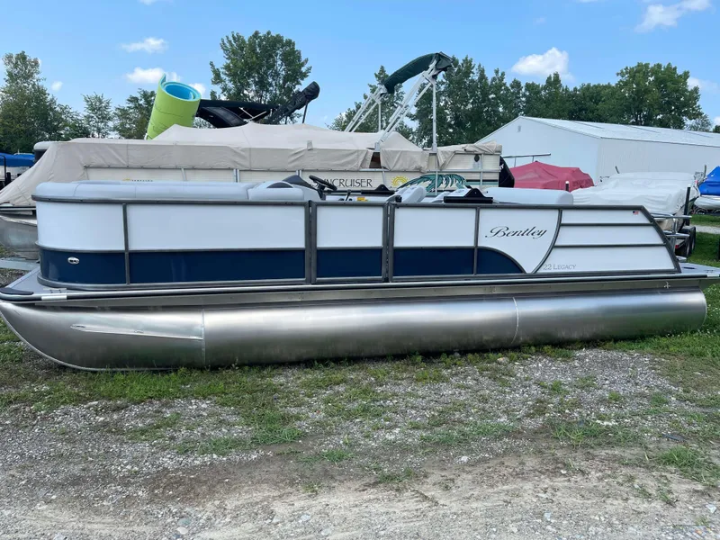 Slide: The Image of 2025 Bentley Pontoons Legacy 220 Swingback pontoon boat on display outdoors. - 3