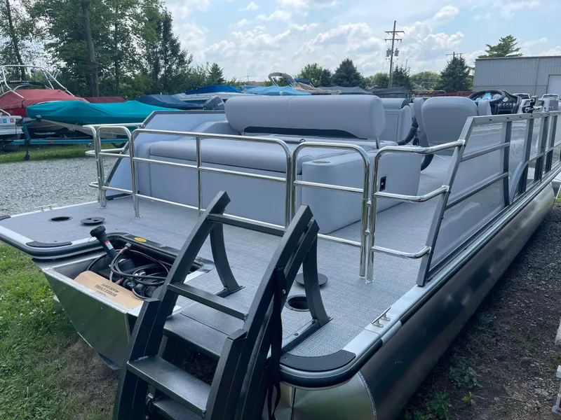 Slide: The Image of 2025 Bentley Pontoons Legacy 220 Swingback pontoon boat with gray seating and ladder. - 6