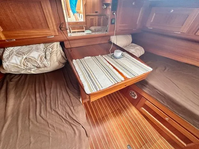 Slide: The Image of Cozy Vilm 116 yacht cabin interior with wooden finish, table, and cup, 2002 model. - 11