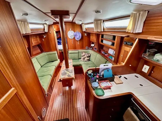 Slide: The Image of Cozy interior of 2002 Vilm 116 yacht with wooden finish and green seating. - 17