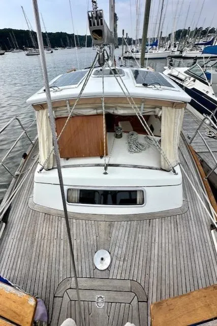 Slide: The Image of Sailboat Vilm 116, 2002 model, docked in a marina with wooden deck. - 2