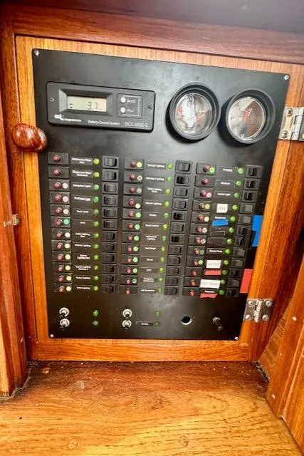 Slide: The Image of Electrical control panel on a 2002 Vilm 116 boat with gauges and switches. - 20
