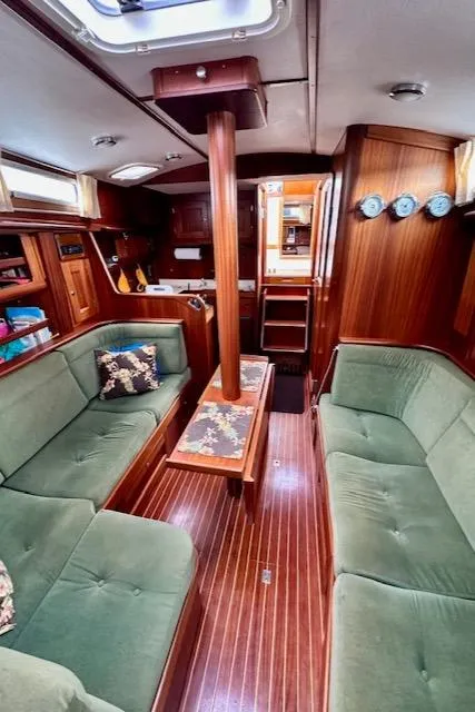 Slide: The Image of Interior of 2002 Vilm 116 yacht with green seating and wooden finishes. - 22