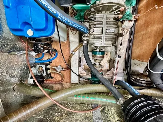 Slide: The Image of Engine compartment of a 2002 Vilm 116 boat, featuring hoses and mechanical components. - 28