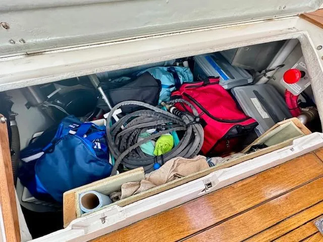 Slide: The Image of Storage compartment of 2002 Vilm 116 boat with bags and coiled ropes. - 29