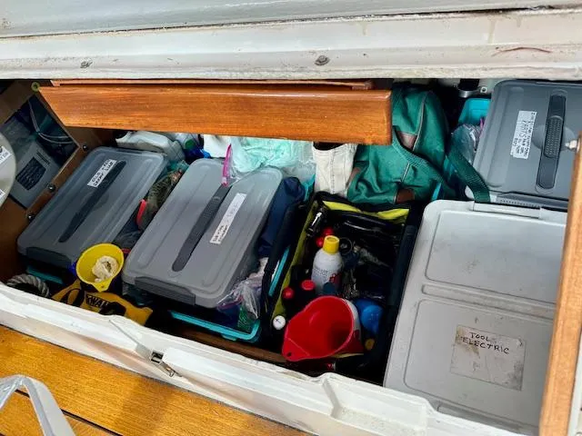 Slide: The Image of Storage compartment on a 2002 Vilm 116 boat with organized tools and supplies. - 30