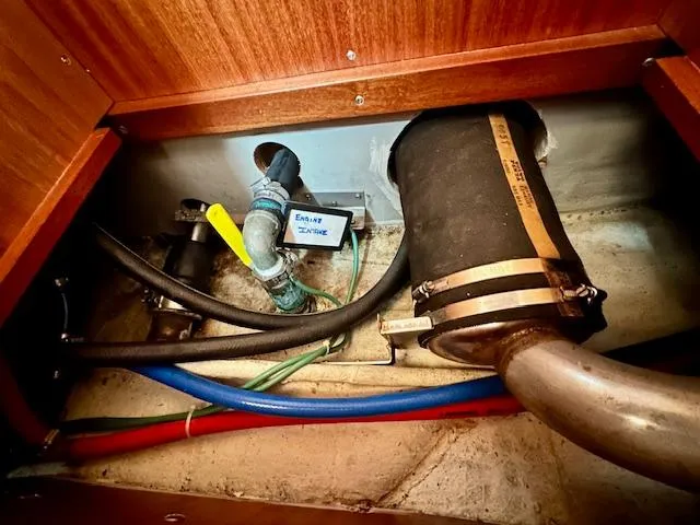 Slide: The Image of Vilm 116 boat engine compartment, 2002 model, showing hoses and exhaust system. - 32