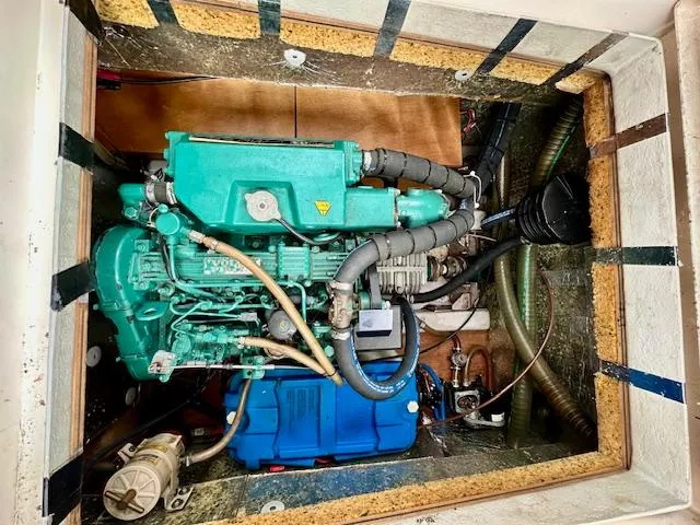 Slide: The Image of Engine compartment of a 2002 Vilm 116 boat, featuring a green marine engine. - 36