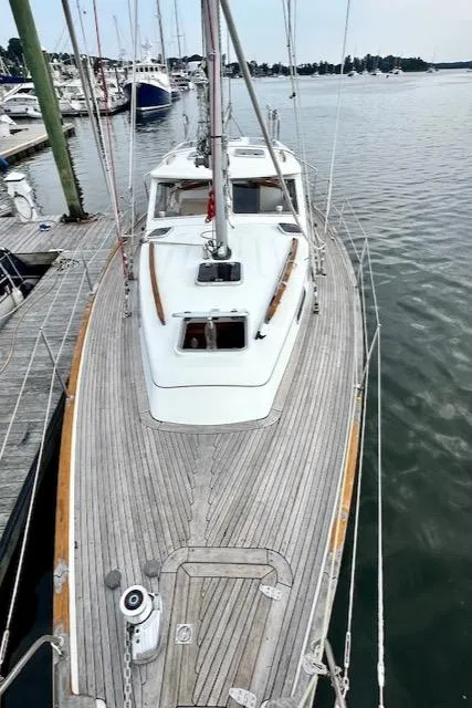 Slide: The Image of Sailboat Vilm 116, 2002 model, docked at marina with wooden deck. - 38