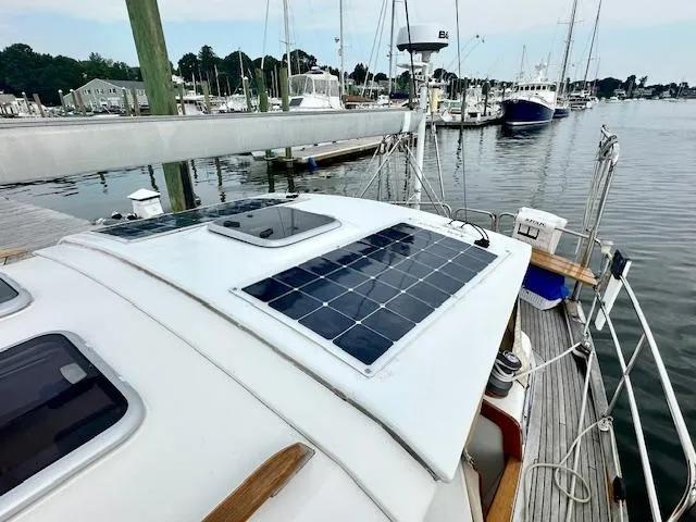 Slide: The Image of Sailboat with solar panels docked at marina, Vilm 116 model, 2002. - 4