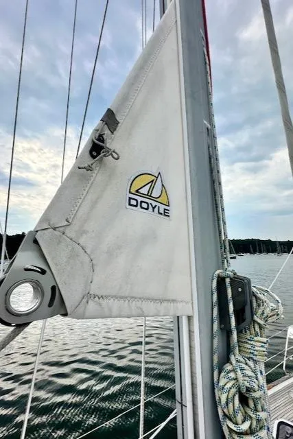 Slide: The Image of Sailboat with Doyle sail, Vilm 116 model, 2002, on calm water under cloudy sky. - 40