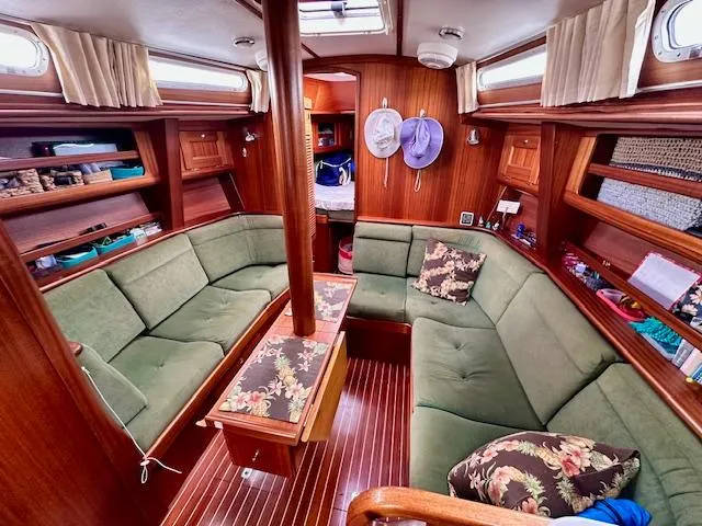 Slide: The Image of Cozy Vilm 116 yacht interior with green seating, wood paneling, and floral cushions, 2002 model. - 7