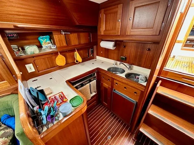 Slide: The Image of Compact wooden kitchen in 2002 Vilm 116 yacht with sink, stove, and storage. - 8