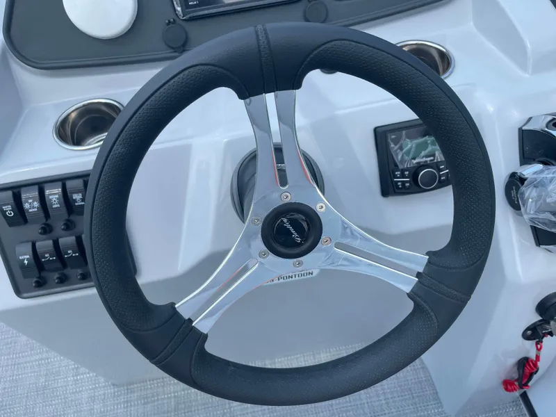 Slide: The Image of 2025 Bentley Pontoons Bolt steering wheel and dashboard controls. - 10
