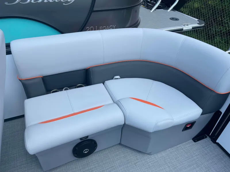 Slide: The Image of 2025 Bentley Pontoons Bolt boat interior with gray and orange seating. - 16