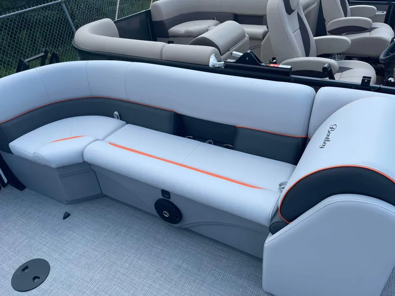 Slide: The Image of 2025 Bentley Pontoons Bolt interior seating with gray and orange accents. - 17