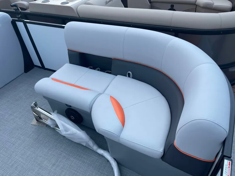 Slide: The Image of 2025 Bentley Pontoons Bolt boat interior with gray and orange seating. - 7