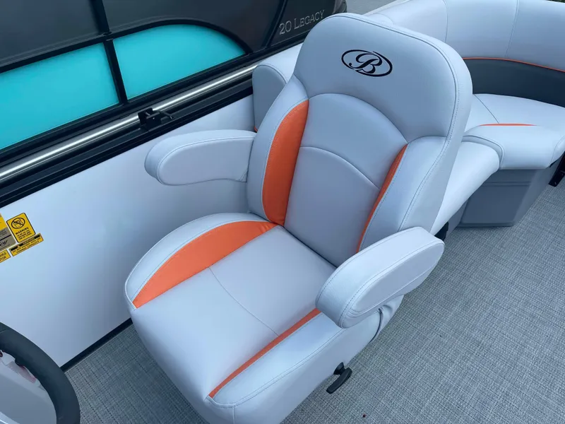 Slide: The Image of 2025 Bentley Pontoons Bolt boat seat with orange accents and armrests. - 8