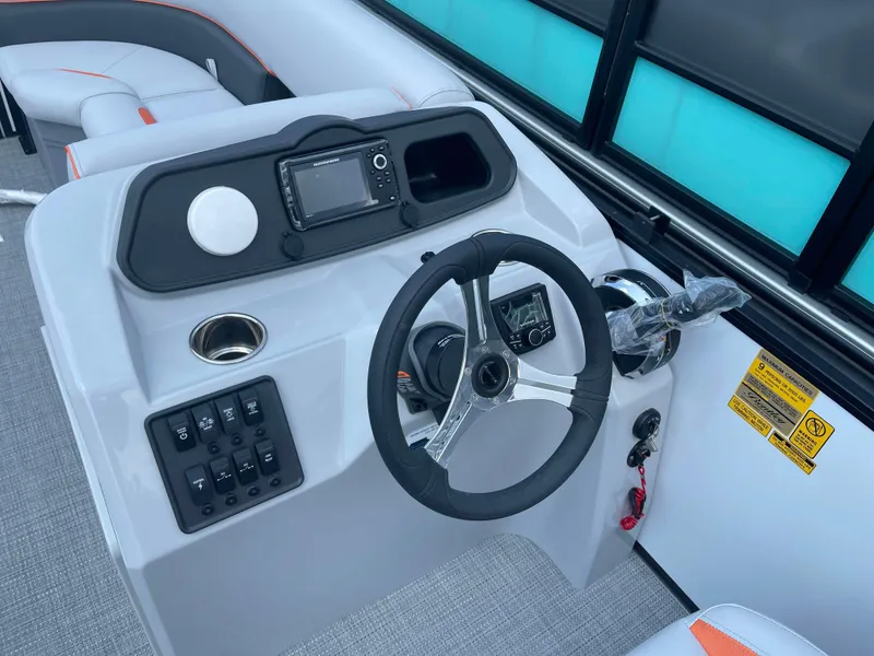 Slide: The Image of 2025 Bentley Pontoons Bolt steering console with modern controls and navigation system. - 9